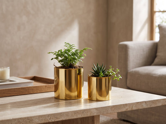 A small and a medium gold stainless steel tabletop planter