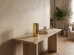 Small Oro Cylinder Vase in mirror-polished gold on a stone console table